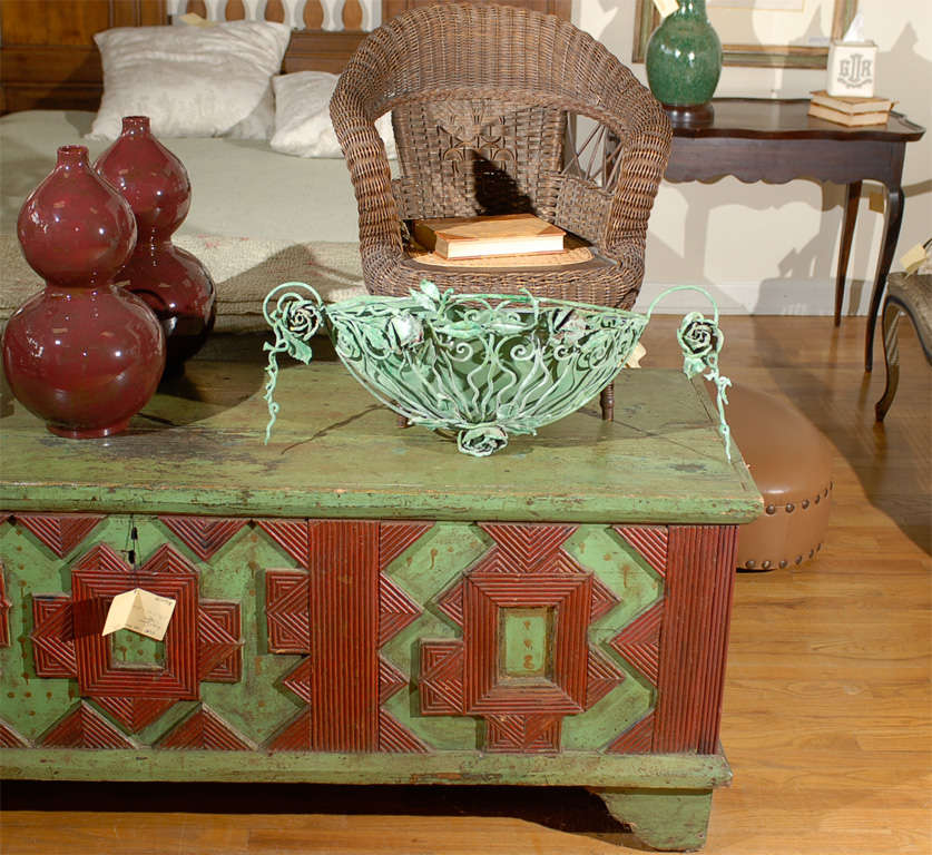 This is a beautiful French planter.  The flower details with ivy weaving through the bars.  The tin is juxtaposed with delicate details.  This is a charming 20th century piece.