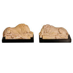 A pair of Giallo Antico carved models of Lions