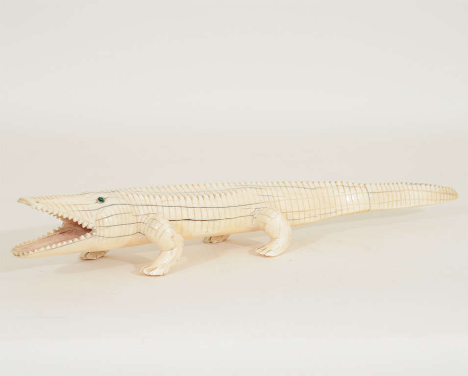 Distinctive Carved Ivory Alligator with Emerald Colored Eyes Standing on Four Open Legs. Late 19th / Early 20th Century

17 inches wide x 4 inches deep x 3 inches high