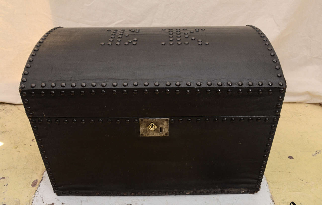 English MID 19TH CENT. OIL CLOTH COVERED DOME TOP TRAVELING TRUNK WITH GUN METAL NAIL HEADS FORMING THE INITIALS EK ON THE TOP & EDGED WITH NAILHEADS. THE INTERIOR LINED WITH PERIOD WALLPAPER --TRAY INSERT WITH BOTTOM MADE OF LINEN WEBBING-- GREAT