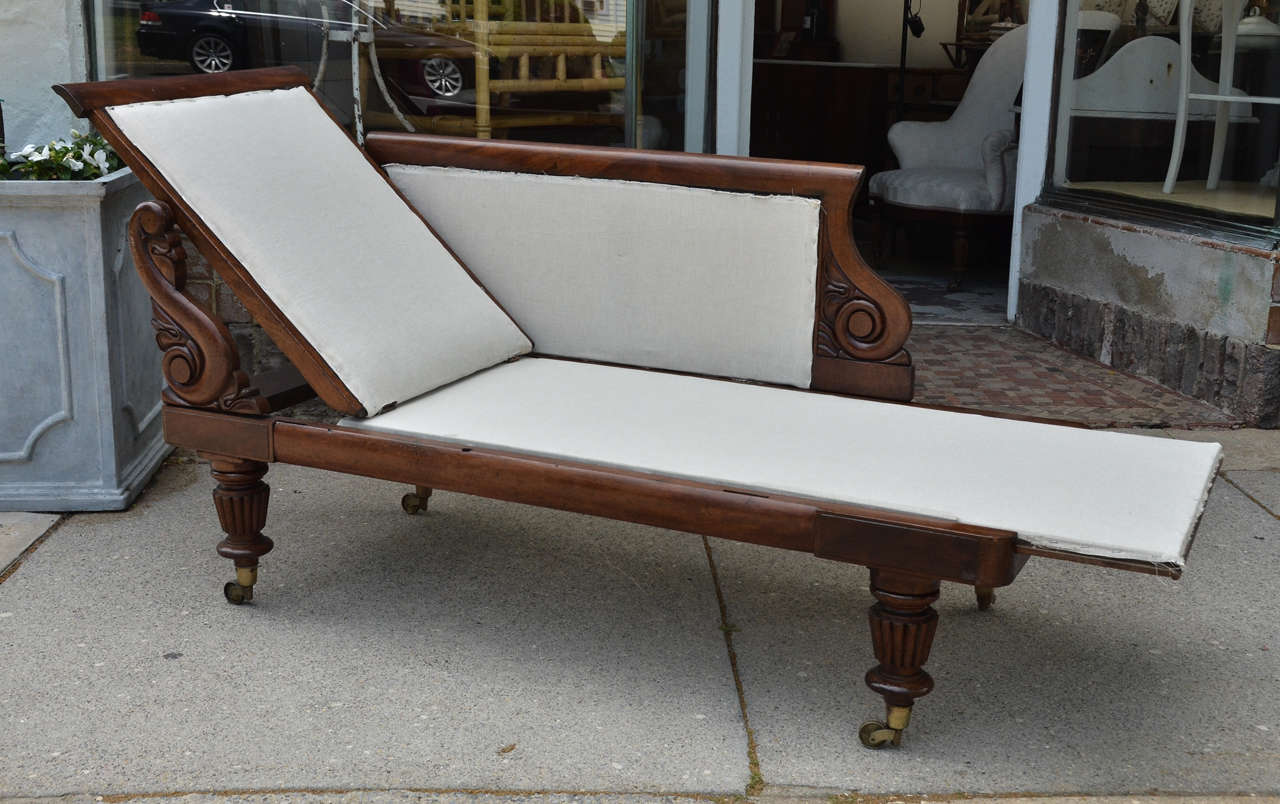 English Regency mahogany framed Recamier (chaise longue) with a slide adjusting seat and hinged back. Side panel can be fixed to either left or right side to allow it face which ever way is desired. The seat should have thin cushion added. The back