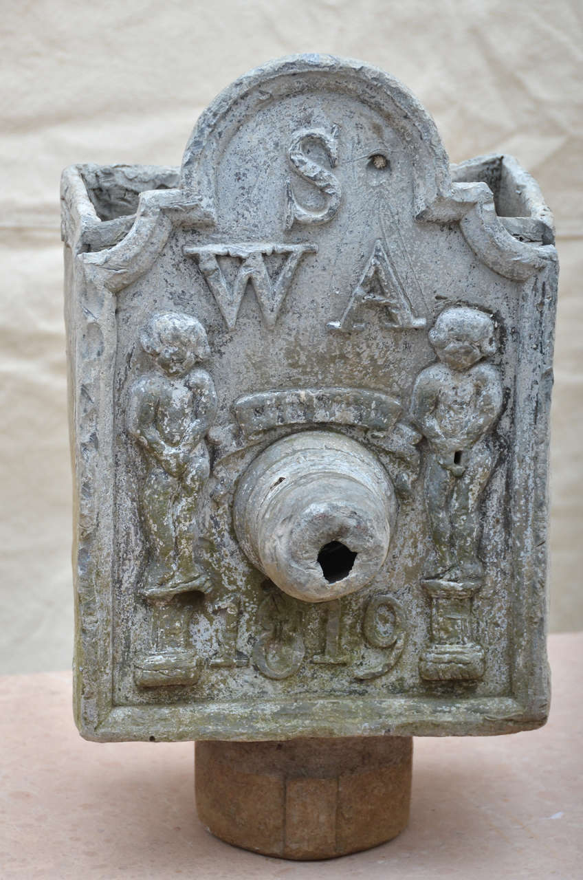English solid lead Tudor style down spout dated 1819. Front panel has arched top centered with the initials W-S-A. Below which are two cherubs on plinths with the date 1819. Was probably made for an early Tudor Revival house or the restoration of