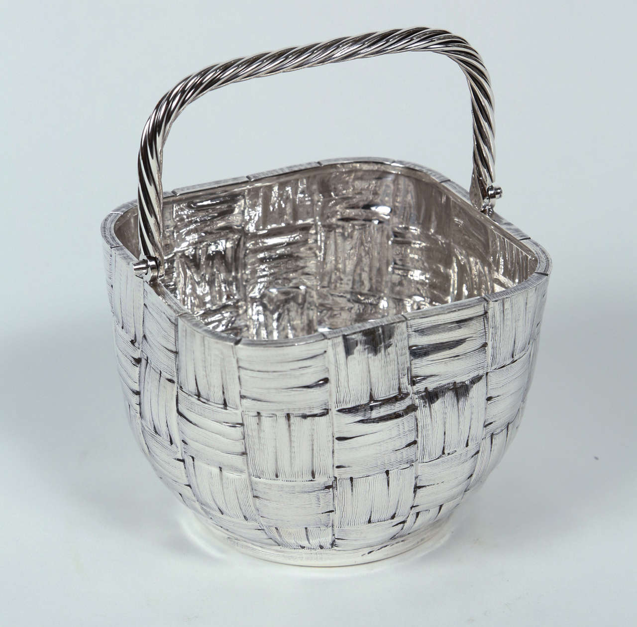 A chic and beautifully detailed Italian Sterling Basket with a moveable handle by Milan-based silversmith Fratelli Cacchione. The bottom of the basket has multiple marks, including the F.C. makers mark, both 
