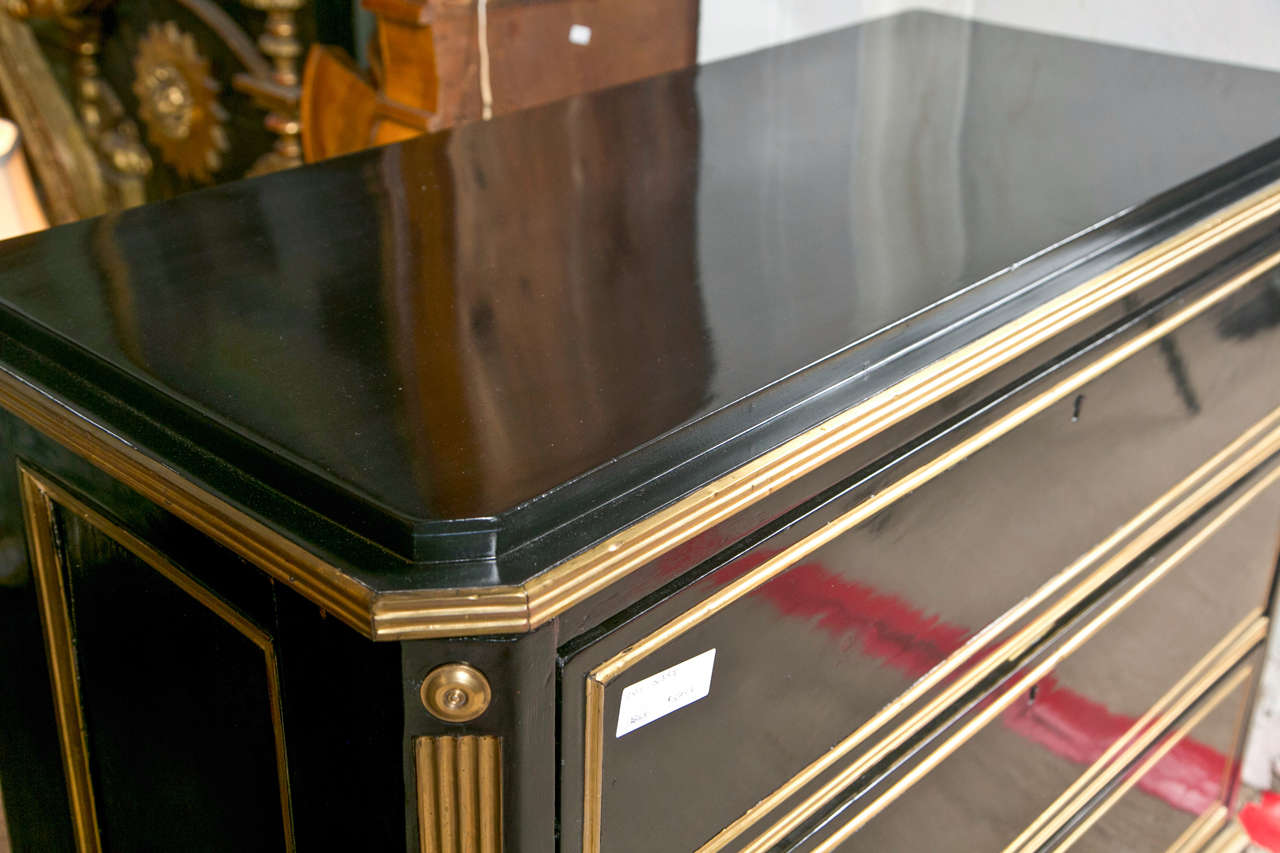 A grand Russian neoclassical style commode or chest of drawers, circa 19th century, overall ebonized and decorated with bronze mounts. The rectangular top over a conforming case fitted with three bronze banded drawers all having antique interiors,