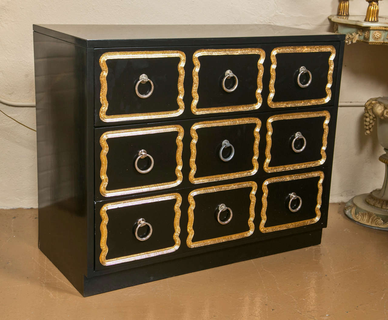 A Pair of Full Sized Dorothy Draper Espana Style Chests. These solid wooden three drawer chests of custom quality. The ebonized finish recently redone to a pristine look. The fine gilt gold framed drawers with pulls. Each having a fine French polish.