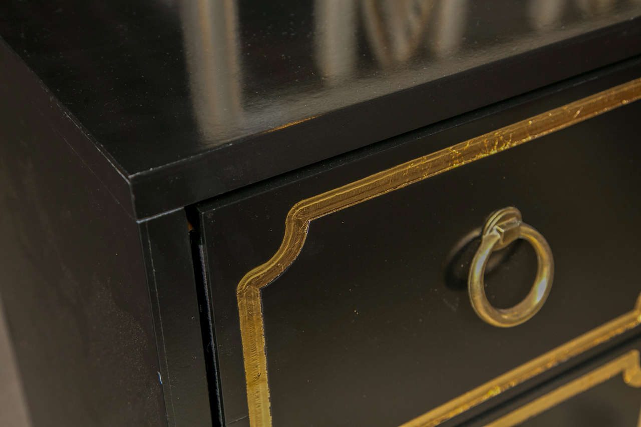 A Pair of Dorothy Draper Espana Styled Chests. These wooden three drawer chests of custom quality. The ebonized finish recently redone to a pristine look. The fine gilt gold framed drawers with pulls.