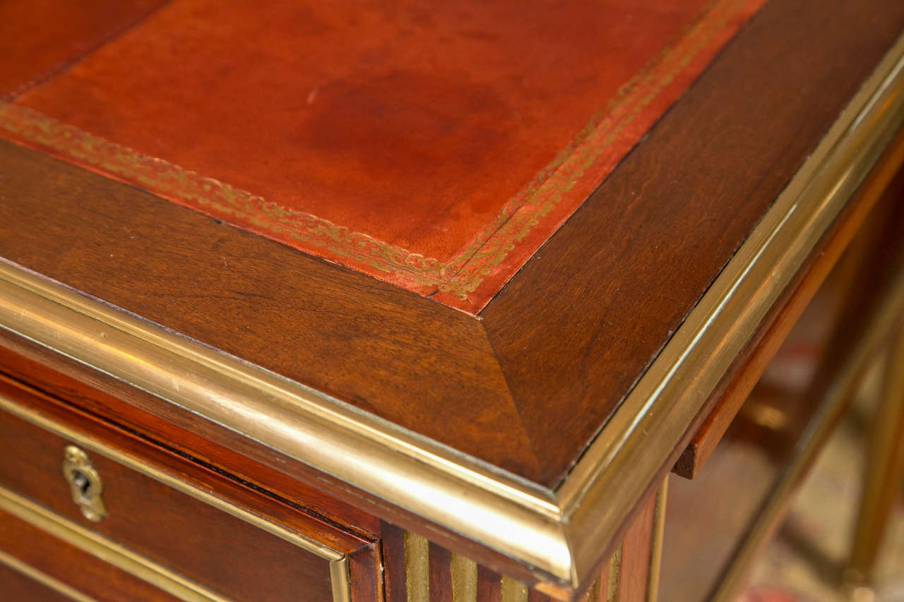 Finest example of Maison Jansen Furniture making is seen is this Louis XVI styled bonze mounted desk. The bronze sabots leading to a tapering legs having finely case bronze mounts. The centre knee hole drawer with a bronze framed flanked by a single