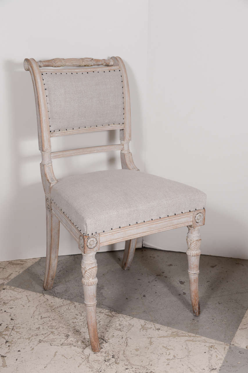Fabulous set of 8 Swedish Gustavian dining chairs, incredible carving. Scraped to the original paint.  Upholstered in an antique linen.