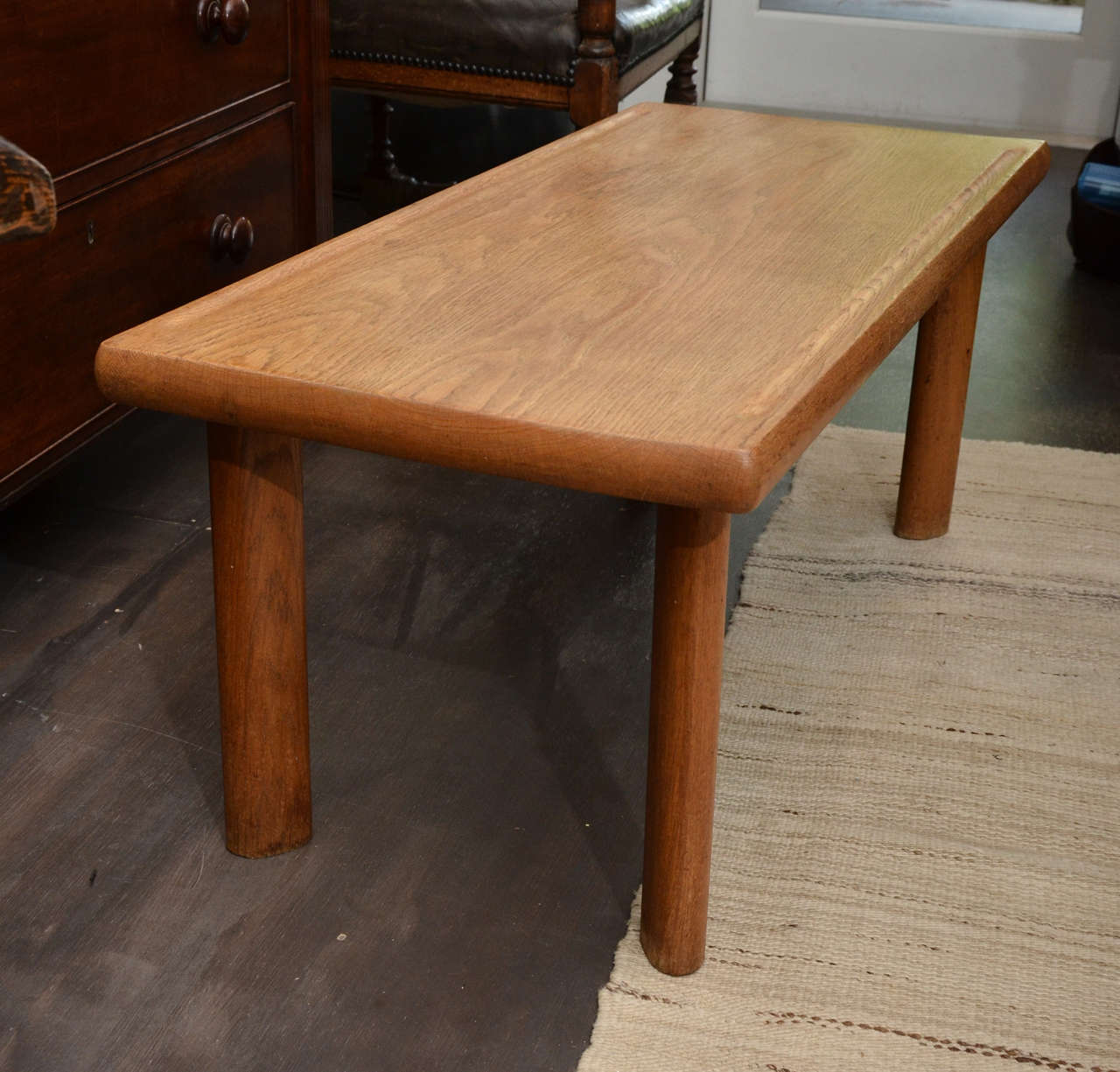 Beautiful and simple oak bench or coffee table with curved and slanted leg detail that is in the manner of Perriand.