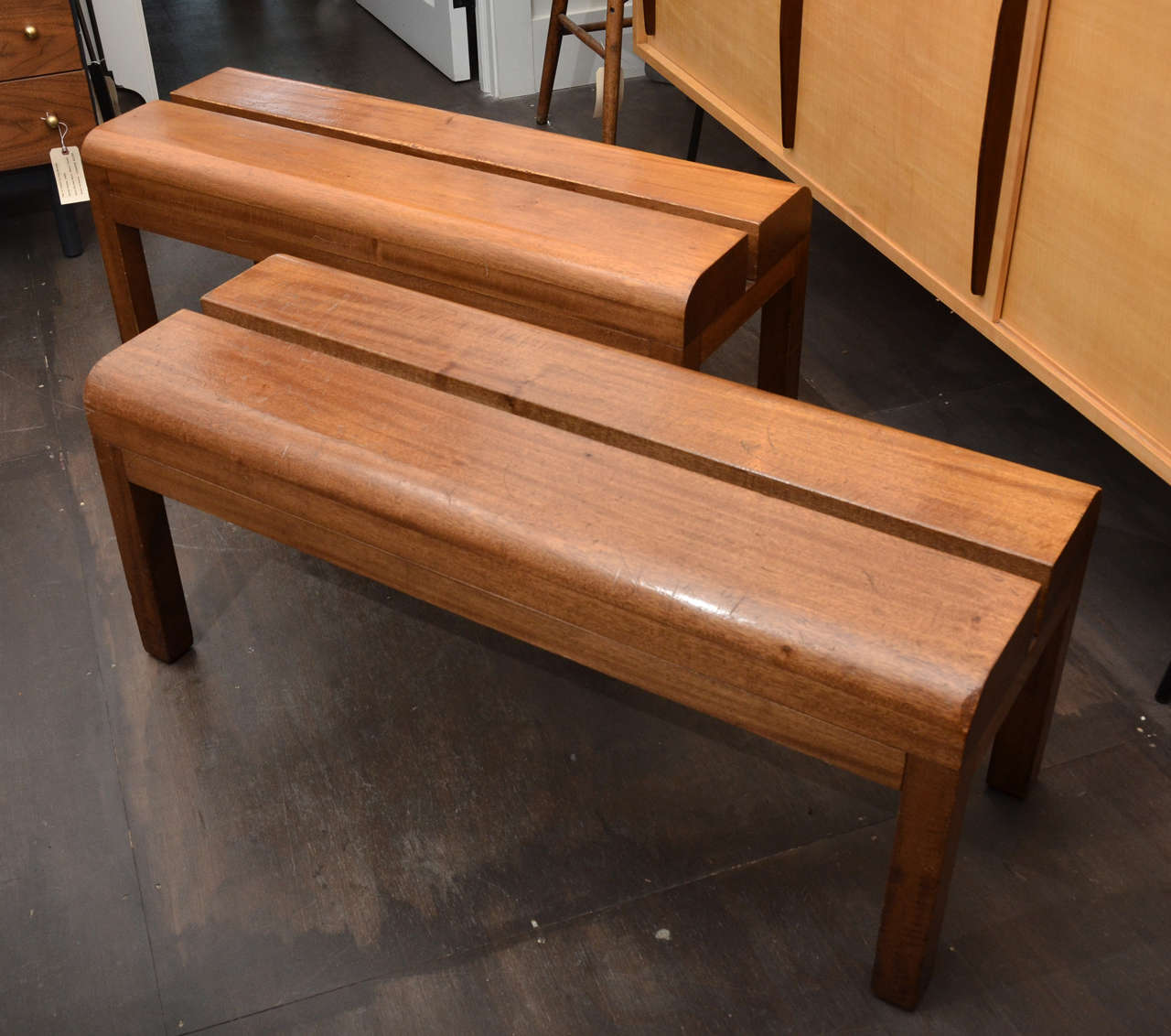 Four Available. 
Wooden benches from french gymnasium. Split detail through center of each bench emphasizes the strong lines of this bench. Curved edges on seat.