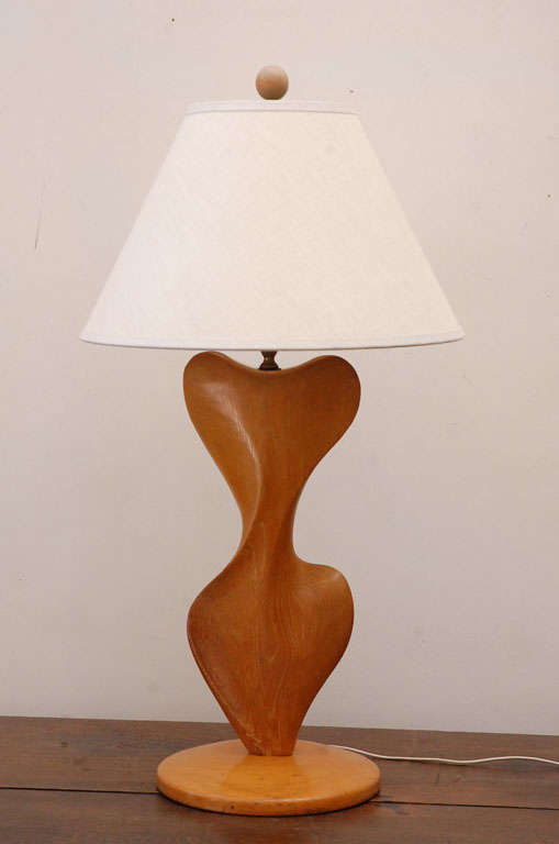 THE CURVES OF THIS DRAMATIC LAMP ARE LIKELY HAND CARVED. IT HAS ITS ORIGINAL  CERUSE FINISH. IT HAS NOT BEEN REWIRED.