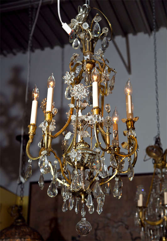 A magnificent eight light early Bagues chandelier having a bronze frame adorned in his signature flowers.