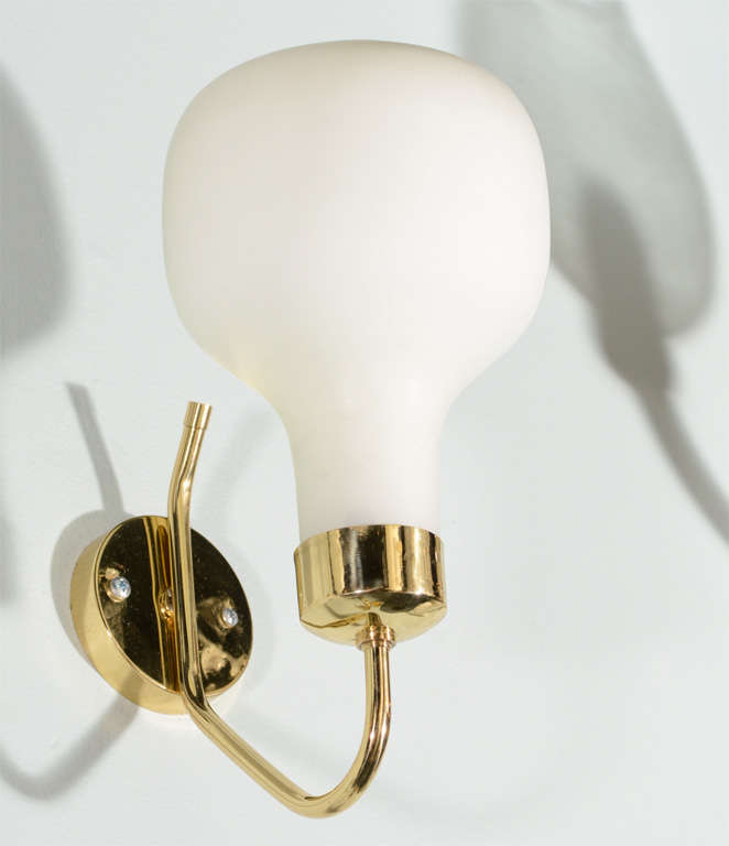 Circa 1950 Italian made sconces in the style of famed lighting house Stilovo. Brass mount with hand blown satin finish case glass balloon shade. Brass polished and lacquered. Sold as a pair. Located in SHOWPLACE ANTIQUE + DESIGN CENTER, NYC,