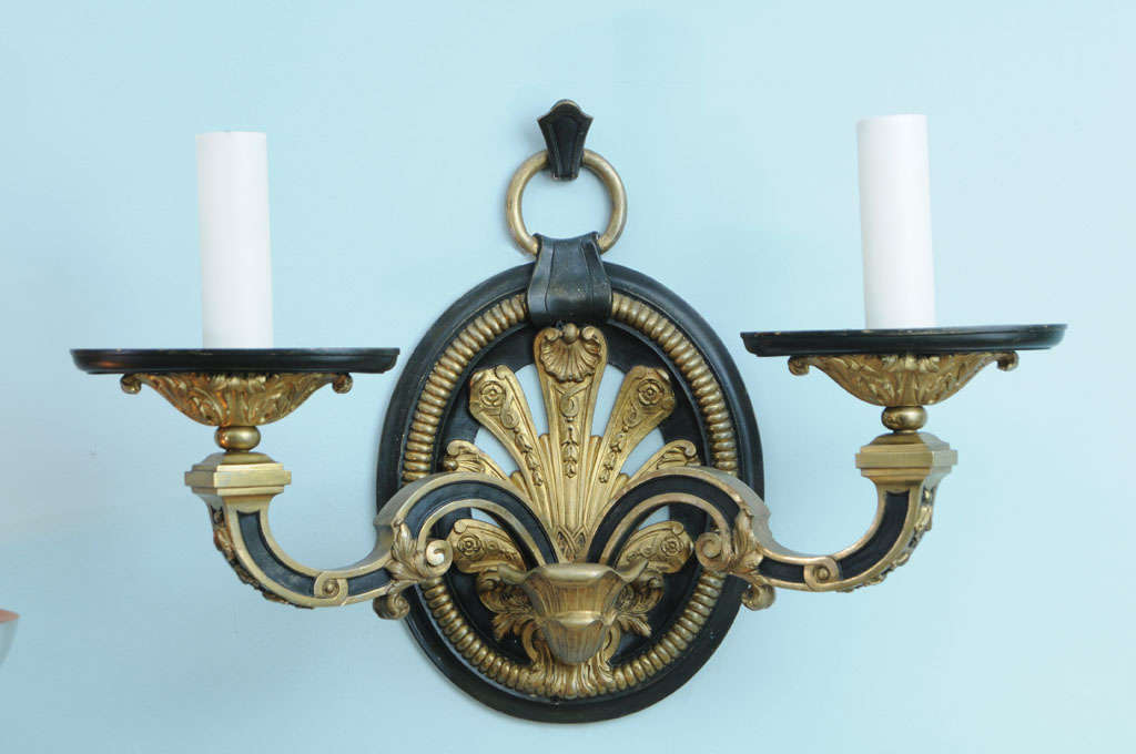 A massive pair of gilt bronze, two-branch sconces with oval feathered medallions, early 20th century. Attributed by E.F. Caldwell. Most probably a mansion or public space special commisioned.