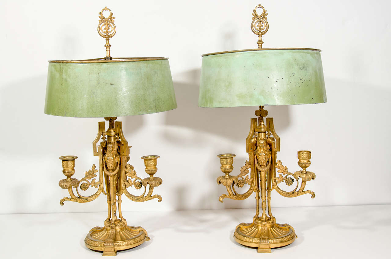 PAIR OF EXCEPTIONAL ANTIQUE FRENCH LOUIS XVI FIGURAL GILR BRONZE BOUILLETE LAMPS OF FINE DETAIL EMBELLISHED WITH GILT BRONZE FIGURAL MASKS & ADORNED WITH ORIGINAL GREEN PATINATED TOLE SHADES, 19TH CENTURY.