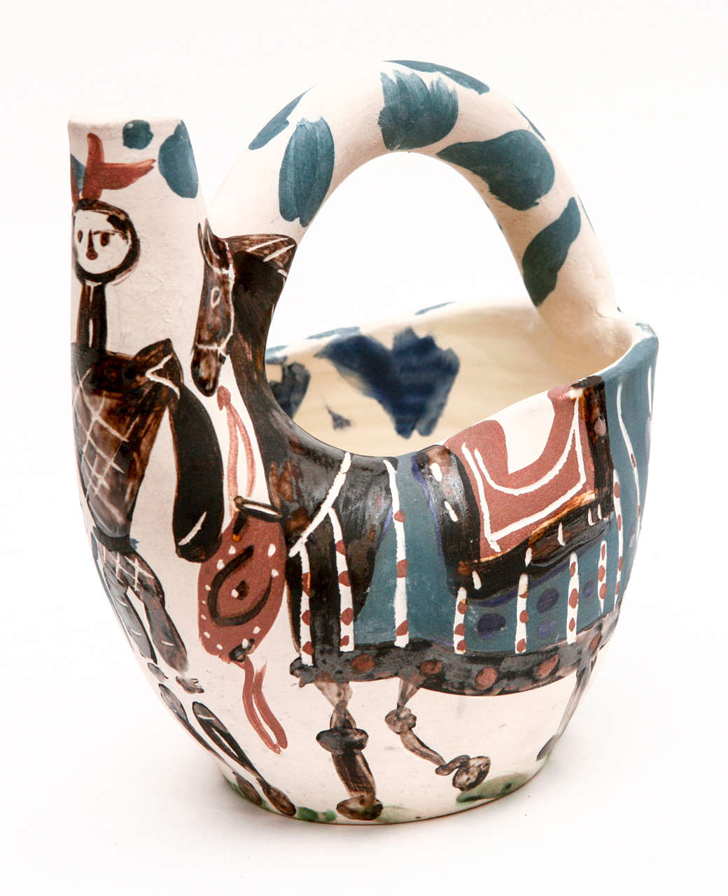 Beautifully decorated and colored, the Cavlier et Cheval (A.R. 137) ceramic pitcher by Pablo Picasso is partially glazed white earthenware clay and is numbered 112/300. Marked 'Edition Picasso' and 'Madoura' and with the 'Edition Picasso' pottery