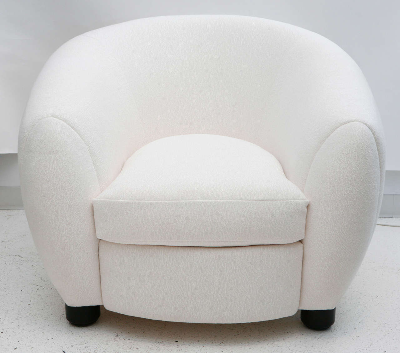 A faithful circa 1980s reproduction of Jean Royère's classic Polar Bear chair, this extremely comfortable oversized armchair has been newly reupholstered in a textured white boucle fabric.