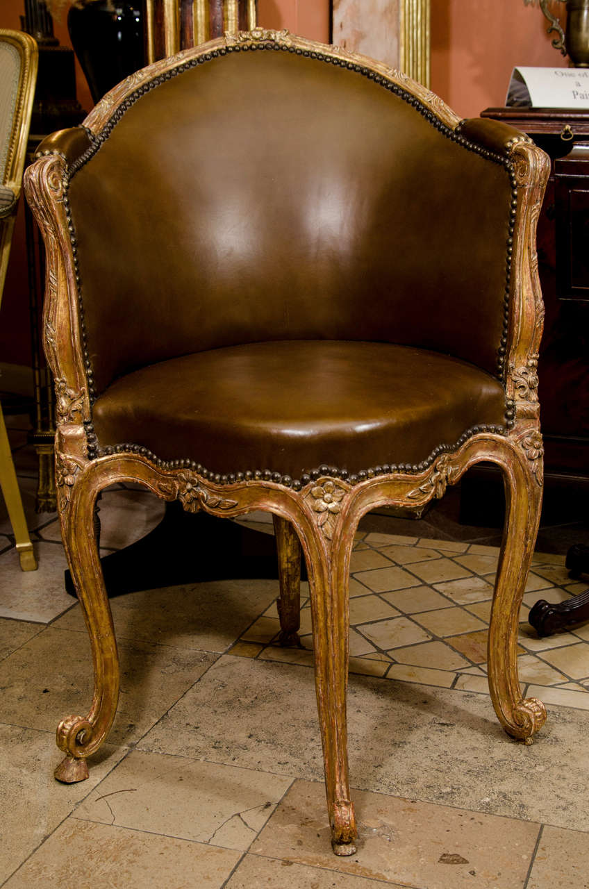 A fine French Louis XV carved Fauteuil de Burea with leather upholstery.  by E. Meunier