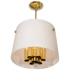 Polished brass chandelier with round frosted glass shade