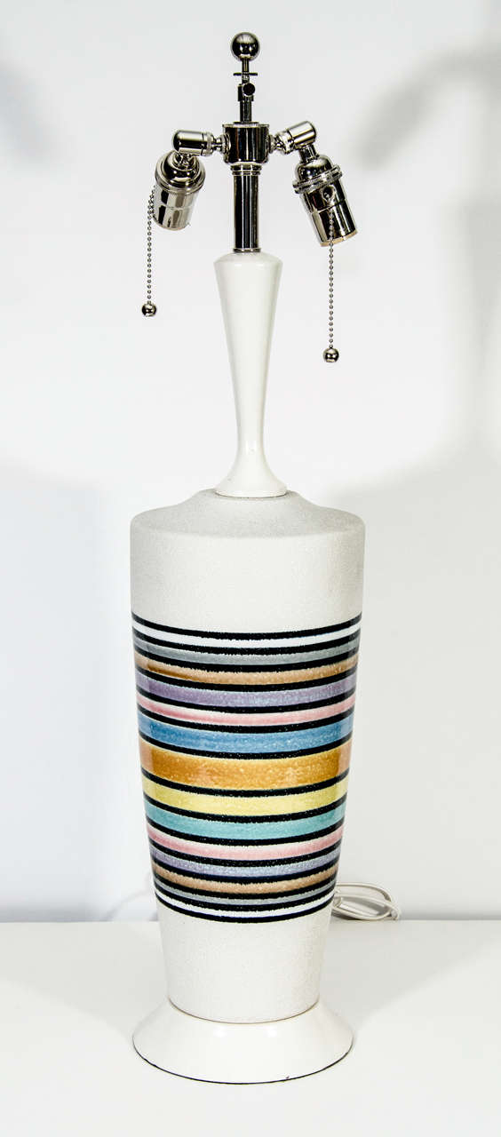 White ceramic stoneware with glazed pastel rings and white painted wood stem and base.