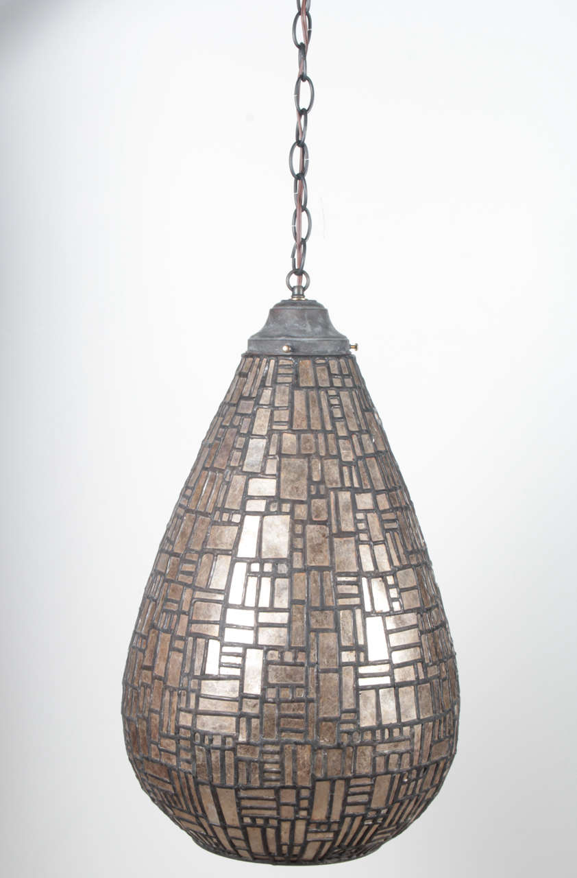 One of a kind pendant hanging light fixture by artist Adam Kurtzman. USA, circa 2000.

Fixture made of leaded mica in a mosaic pattern.

Measures 20