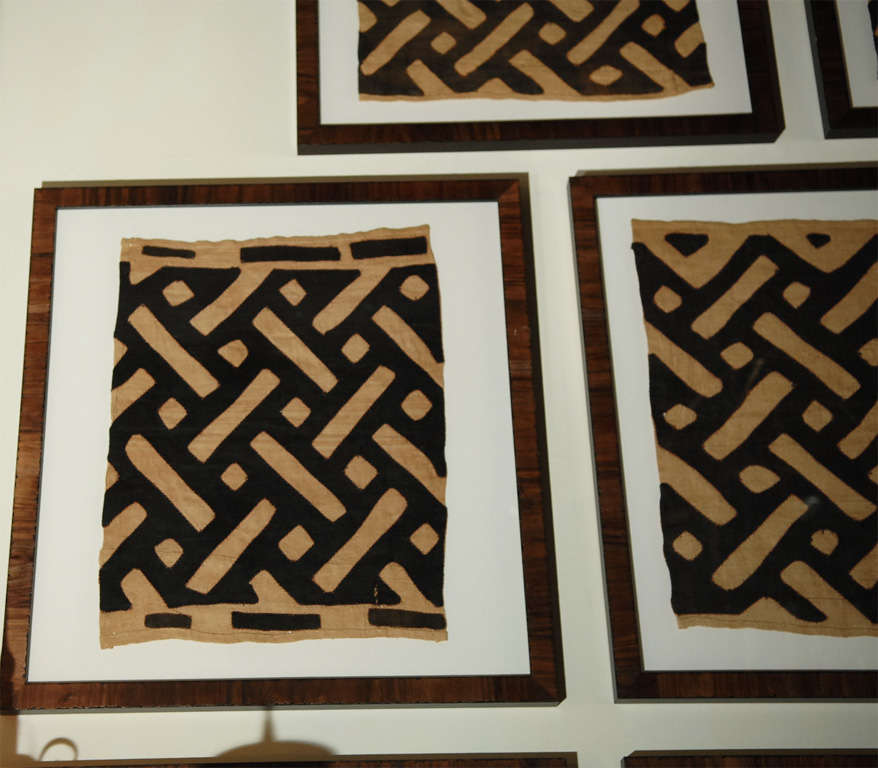 Set of Eight Old Kuba Cloth Textiles in Replica Burl Walnut Frames.