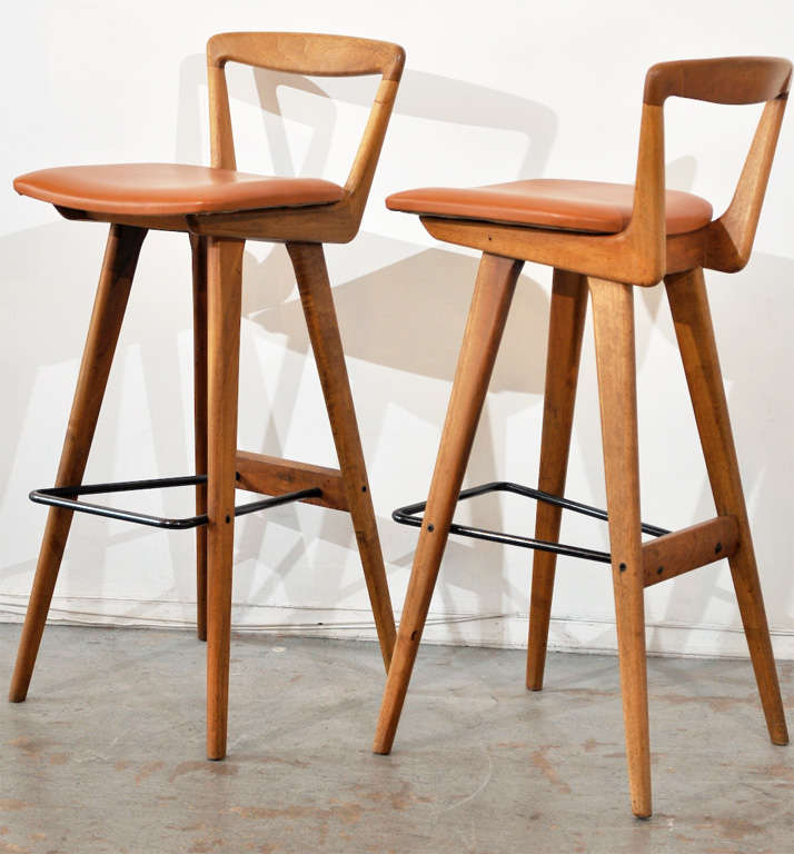 These Danish bar stools, designed by Henry Rosengren Hansen for Brande Møbelfabrik, incorporate some really cool forms, with great craftsmanship and attention to detail. One's eye is particularly drawn to the way the tubular metal stretcher doubles