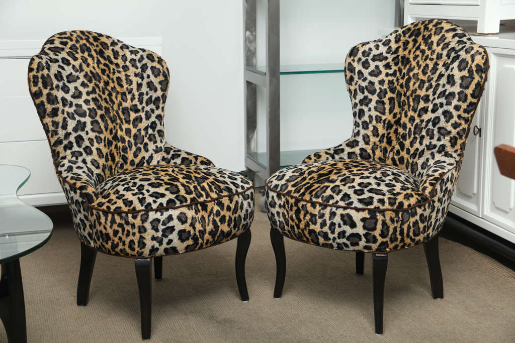Beautiful pair of luxurious faux leopard skin bedroom sleeper chairs.. newly reupolstered..with chocolate ultrasuede trims and newly lacquered legs indark  chocolate color