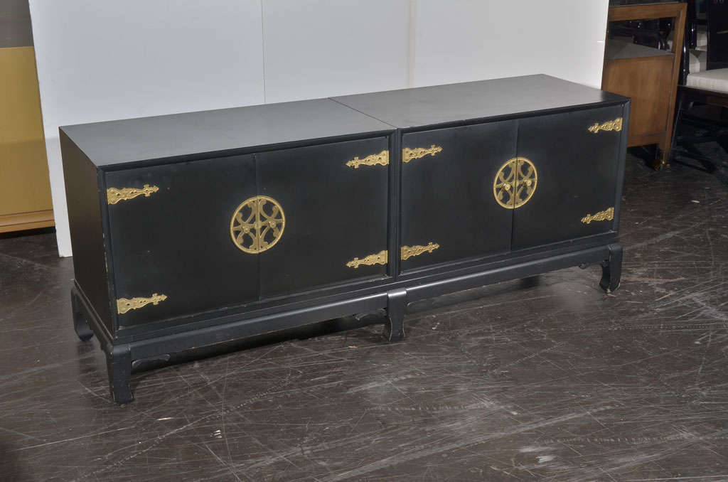 Three-piece Asian console/credenza with Ming legs and stylized brass hinges and handles. Three pieces include base, plus two two-door components.