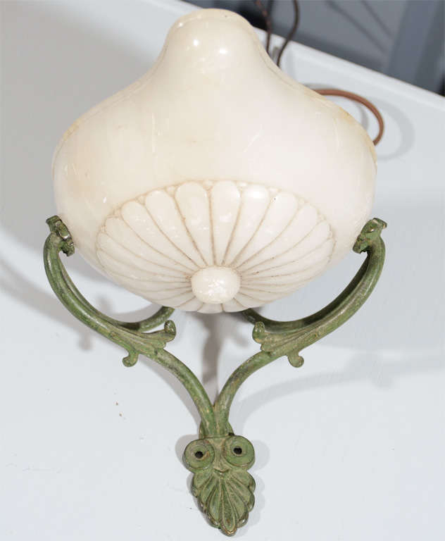 Pair of French alabaster and patina metal sconces.