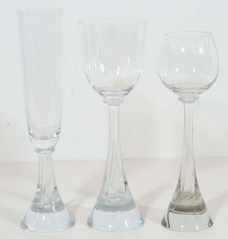 This gorgeous set features 16 champagne glasses,16  water/white wine glasses and Red wine glasses  These are hand blown and are of exceptional quality. They feature a stylized tear drop design.