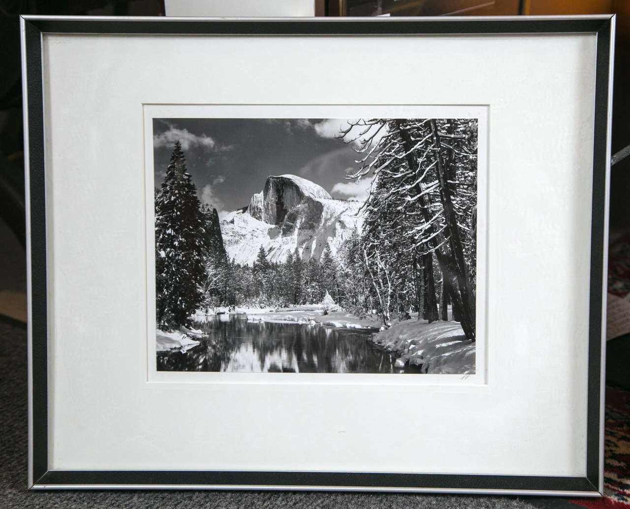 Framed silver gelatin print of half dome in winter with Merced River.  AA Initialed lower right.  Printed by Alan Ross from original negative.