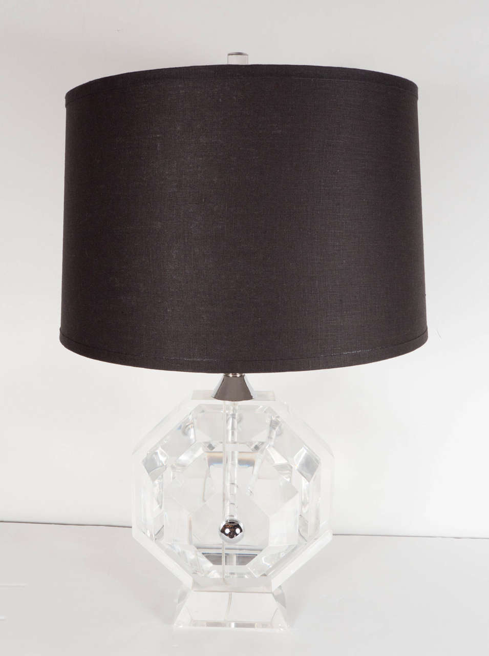 This magnificent pair of Mid-Century Modernist table lamps by Prismatiques feature an octagonal thick Lucite form shape with chrome detailing on the neck and centre base. These are high quality lamps and are in excellent condition and they have been
