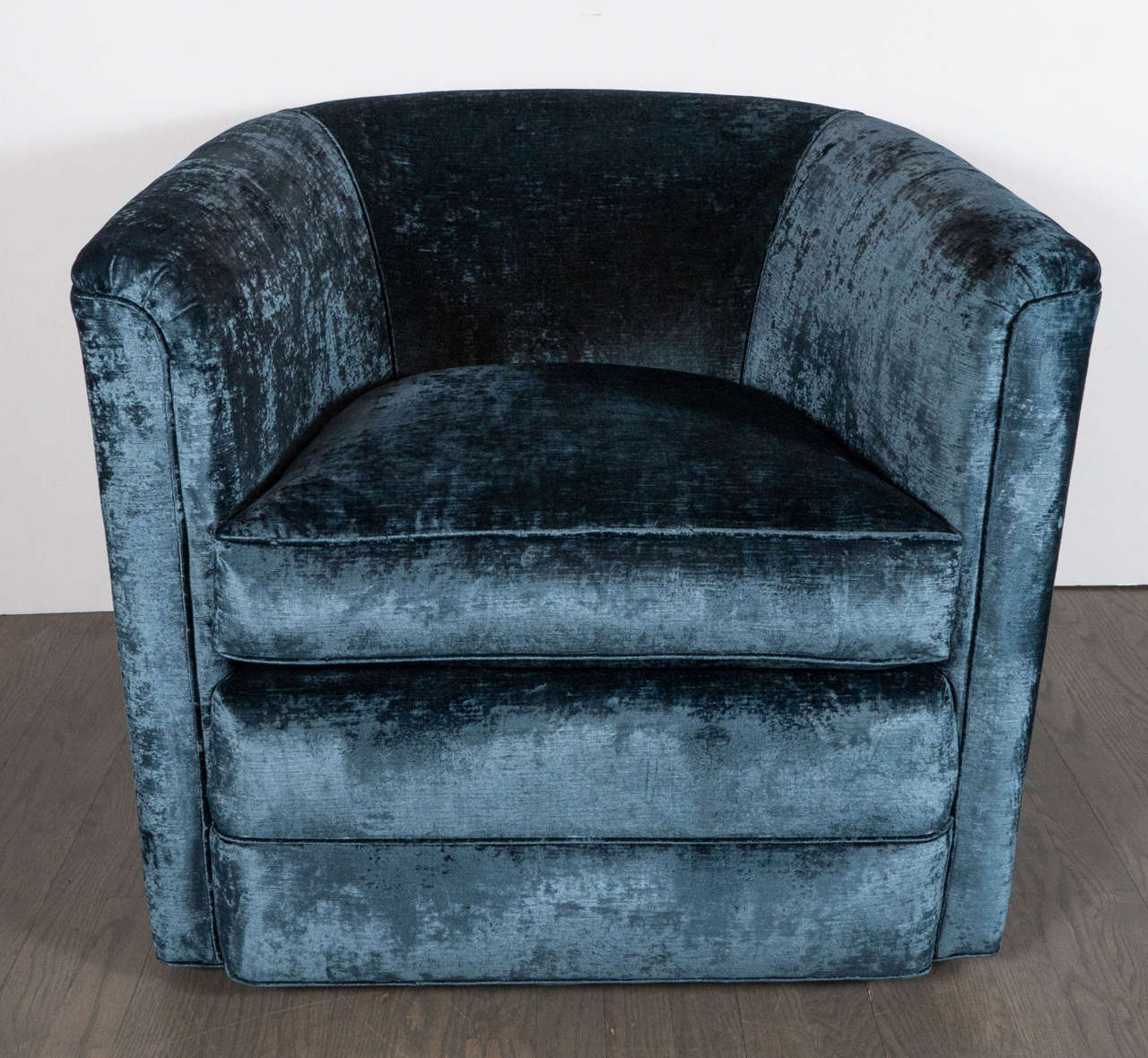 This exceptional pair of Mid-Century Modernist swivel club chairs are by Milo Baughman. They feature a sumptuous antique sapphire velvet upholstery and would be perfect in any room or decor. These chairs have been newly upholstered and mint restored