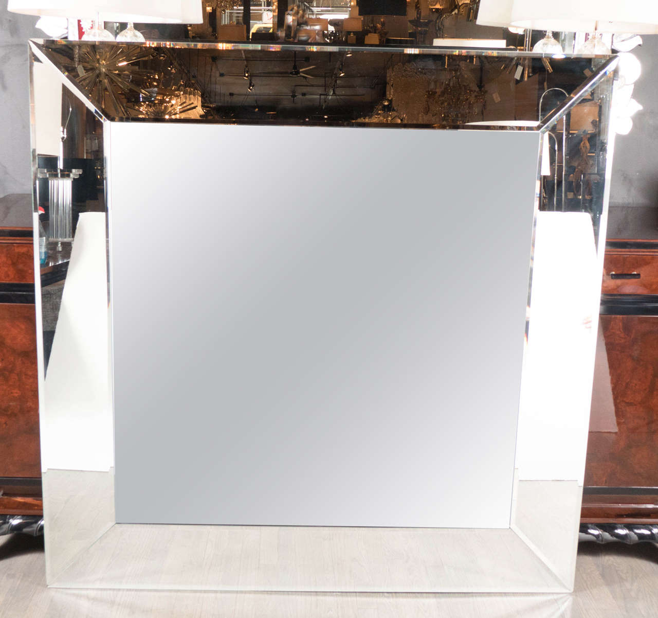 This Mid-Century Modernist mirror is not only magnificent in size but in it's design. It features a beveled square form with a secondary layer on the outside. It is in excellent condition as well.