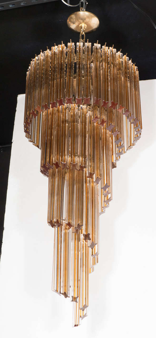 This exquisite chandelier by Camer features a stunning spiral descending crystal detail in amber and clear. It has been newly rewired and it is in excellent condition.