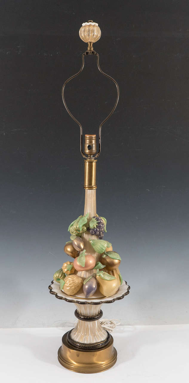 Intricate Murano glass table lamp, infused with gold flecks, produced, circa 1940s by Barovier & Toso, the body depicted as an assortment of fruits,Pears ,Figs,Grapes,Bananas and Plums and more. Above a raised platter, on a circular brass base;