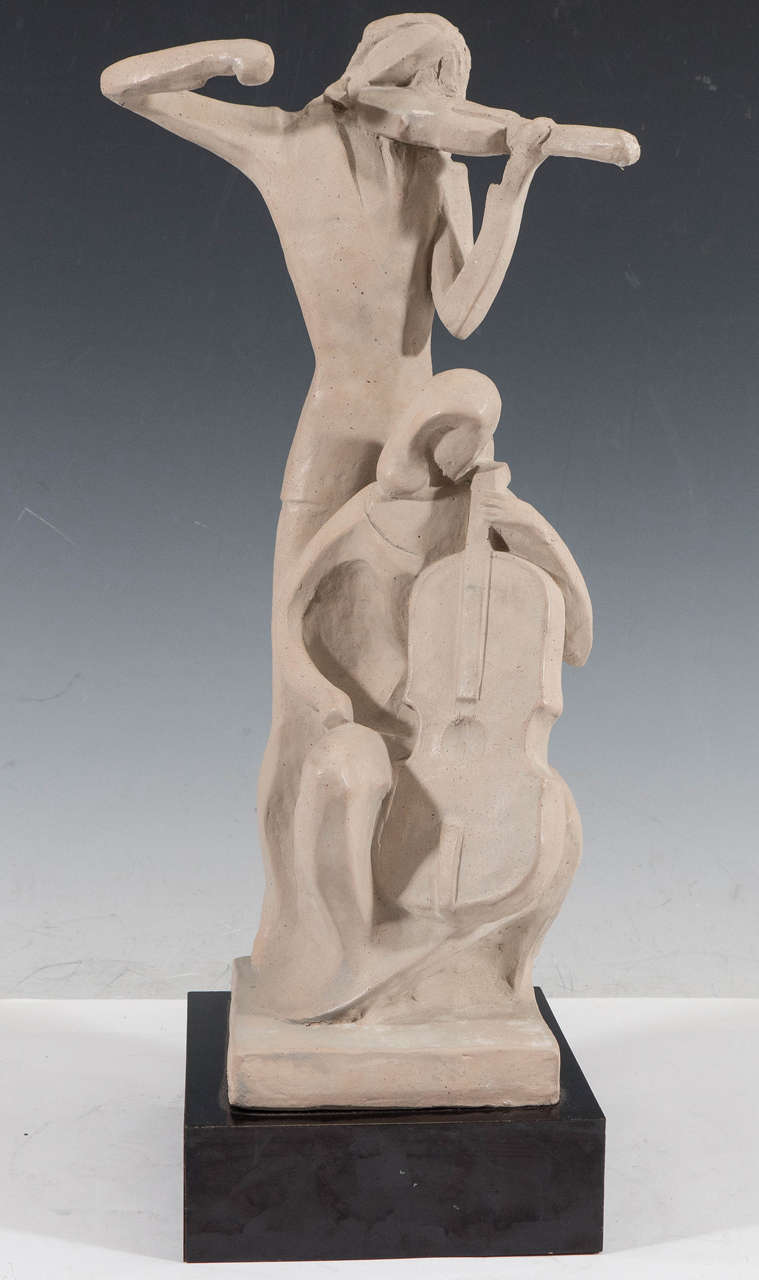 A vintage sculpture of a duo of stringed musicians, produced 1980 by Austin Productions Inc., in dense plaster on a black lacquer wooden base. Following a stylistically abstract mode, the figures are depicted playing the violin and Cello. Markings