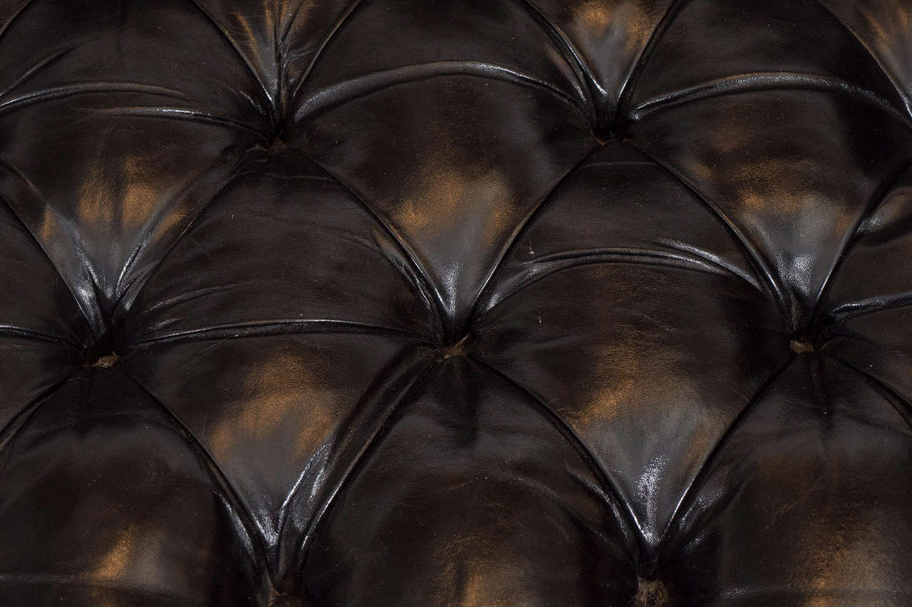 tufted black leather couch