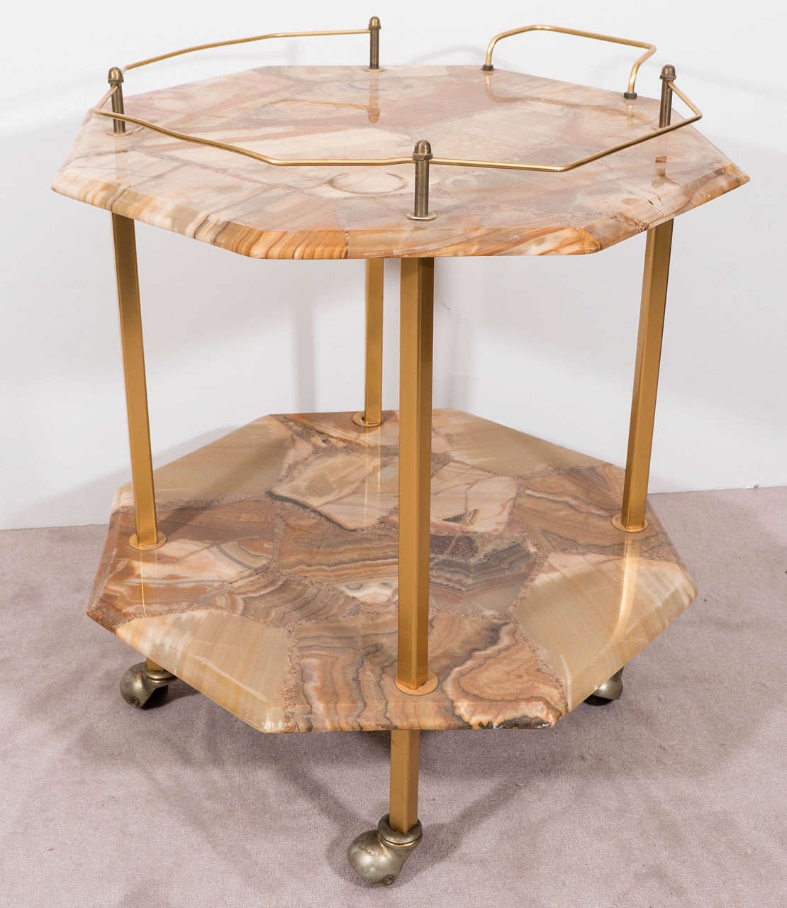 A vintage cocktail cart, produced, circa 1960s, with two octagonal shaped tiers in polished agate, with a handle, gallery and four legs in gilded brass, on casters. Good vintage condition with minor age appropriate wear and faint patina to the brass.