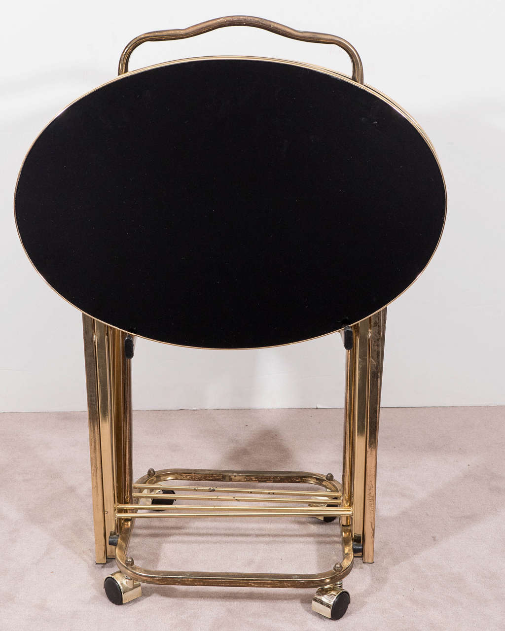 20th Century Set of Four Hollywood Regency Brass Frame Dinner Trays with Black Glass Tops