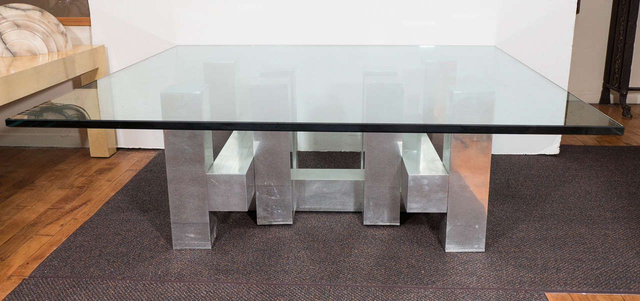 A vintage coffee table, produced between 1960s-1970s by designer Paul Evans, with glass top over a brushed steel base, in the geometric form of the designer's iconic 'cityscape' style. Good vintage condition, with age appropriate wear and some