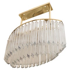 An Oval Chandelier in Brass and Glass Prisms by Venini
