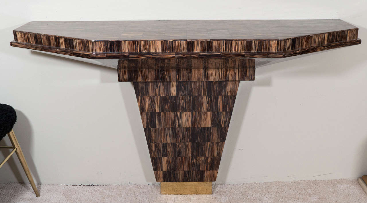 A vintage, highly modern wall mount console table, produced circa 1970's and inspired by Karl Springer, with tessellated horn inlay on a brass plated foot. Good vintage condition with some age appropriate wear.