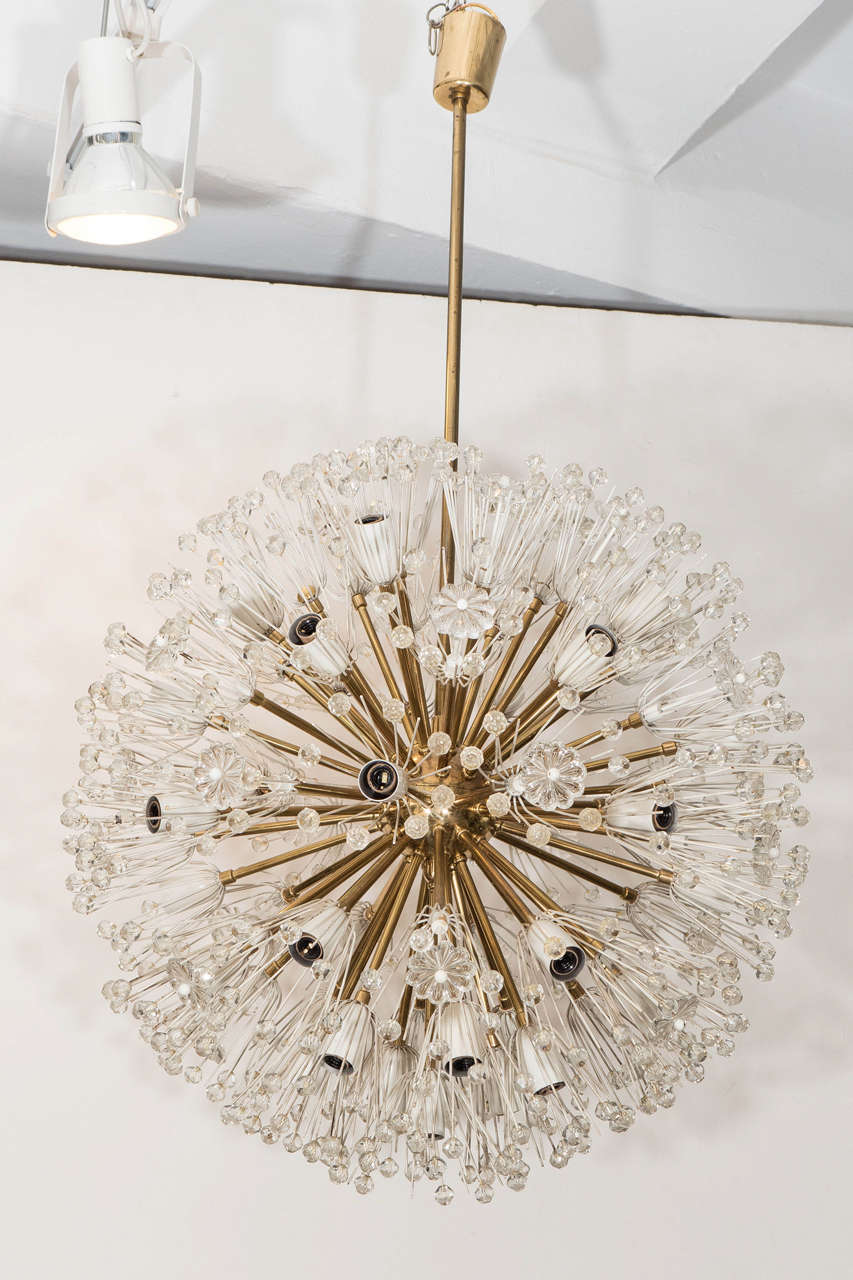 A large sized sputnik chandelier, produced circa 1950's by Austrian designer Emil Stejnar, with cylindrical canopy, central pole, nucleus and arms in brass, surrounded by white enamel socket covers and stems, decorated with faceted glass beads and