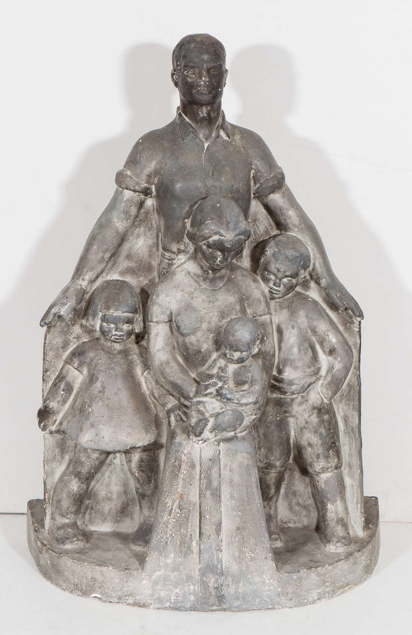 A vintage sculpture of a family, produced, circa 1930s by an unknown, possibly American artist, in plaster with a grey glaze. The piece, likely a study or maquette for a monumental sculpture, depicts the sentimental image of a family unit, with