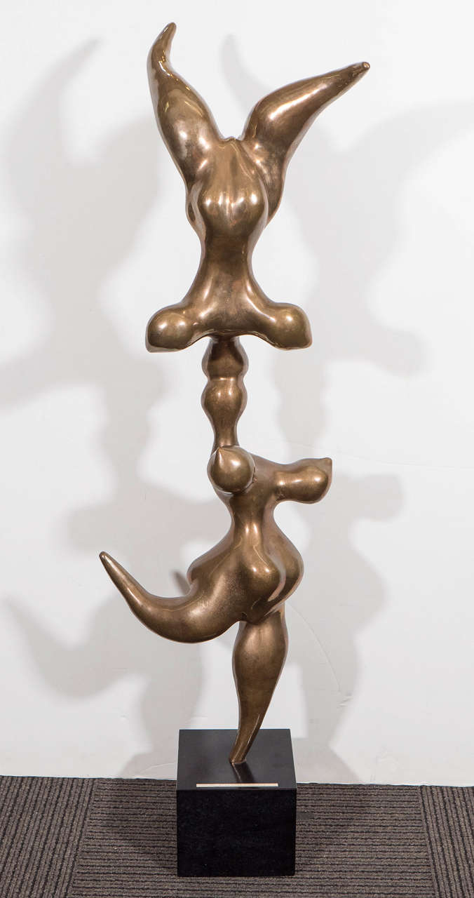 A modernistic vintage sculpture, produced circa 1960s by sculptor Lewis Seiler depicting two highly abstracted, rounded figures in bronze, whom appear to be performing outstanding acrobatic feats, and deftly balanced on a black marble base. Markings