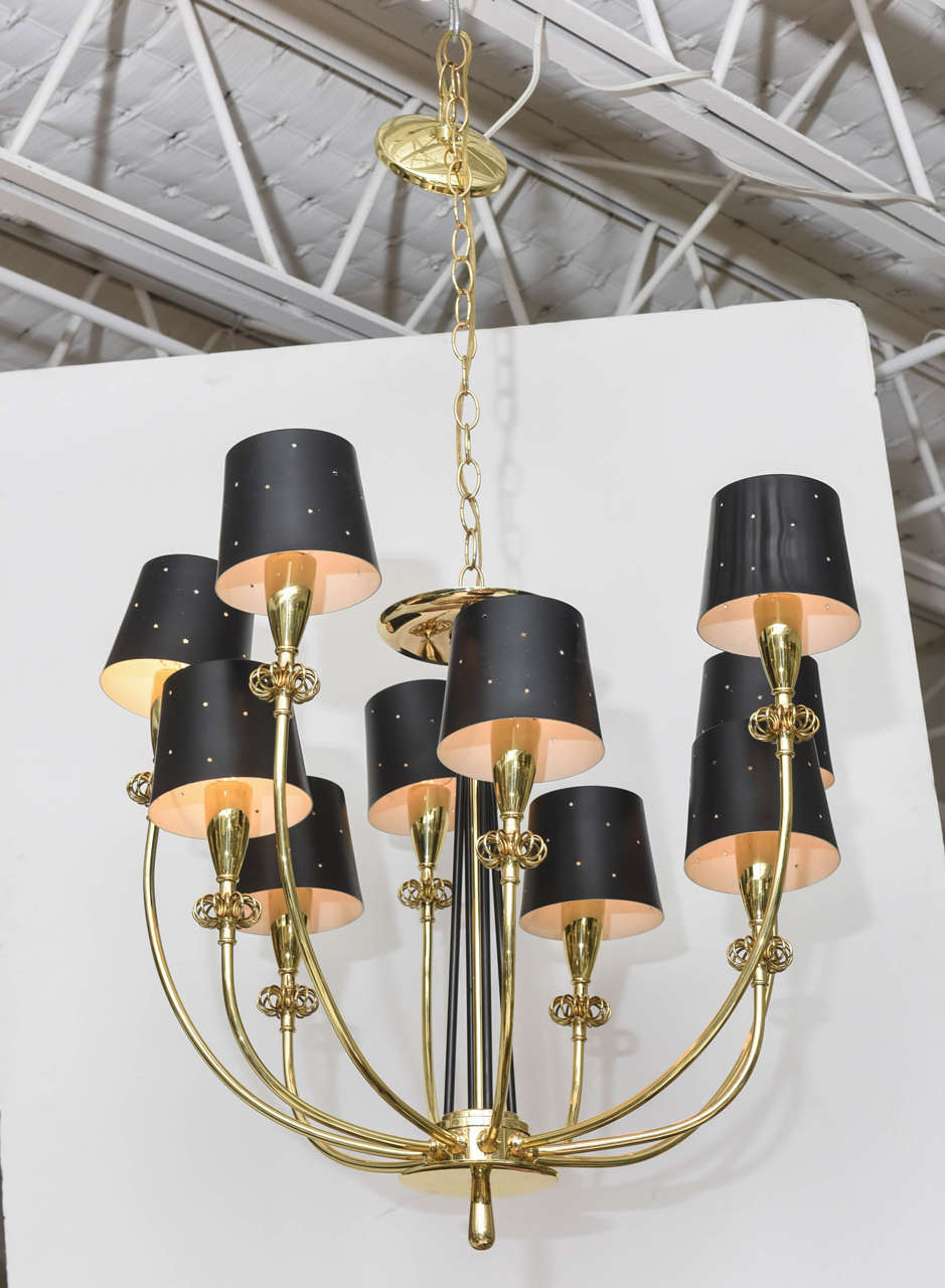 Magnificent polished brass ten-arm Lightolier chandelier with black perforated metal shades and wire flourishes in the manner of Paavo Tynell. Professionally polished and re-wired.