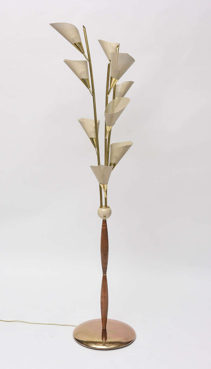 Fantastical 1950s Italian floor lamp has nine lights with cream enameled, perforated metal shades. Polished solid brass arms, finished wood stem and metal base.