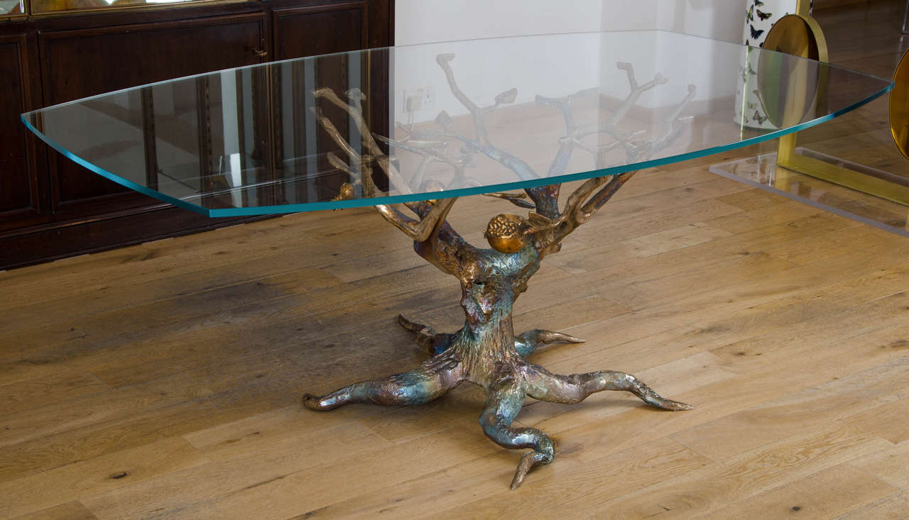 British, 2015, limited edition of 8
cast bronze with rainbow patina, the pendant 'fruit' highly polished contrasting with the matt finish to the 'tree'
with curved rectangular glass table top
base signed by the artist, and with certificate